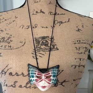 Butterfly Mask Pendant Necklace on a silk rope .